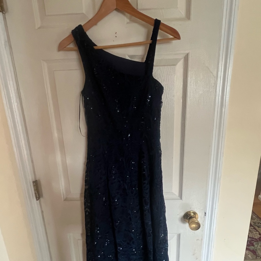 I am selling a dark blue sequined size four one shoulder dress for $20.